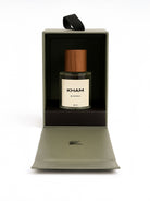 Perfume bottle with wooden cap in a black box on a white background